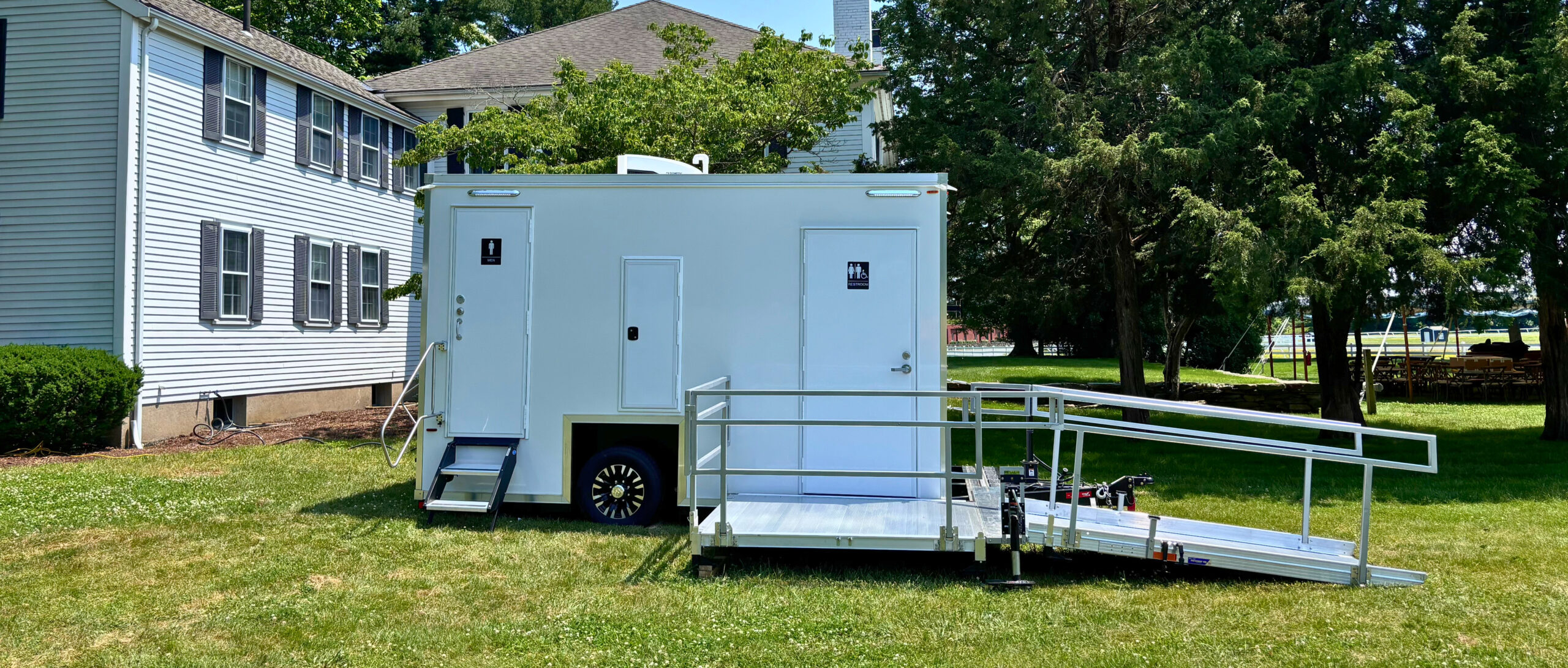 Luxury portable restroom trailer set up for an event, providing clean and spacious facilities.