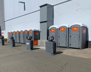 Portable toilet and restroom trailer rentals by The Throne Depot serving athletes and spectators at an outdoor sports tournament
