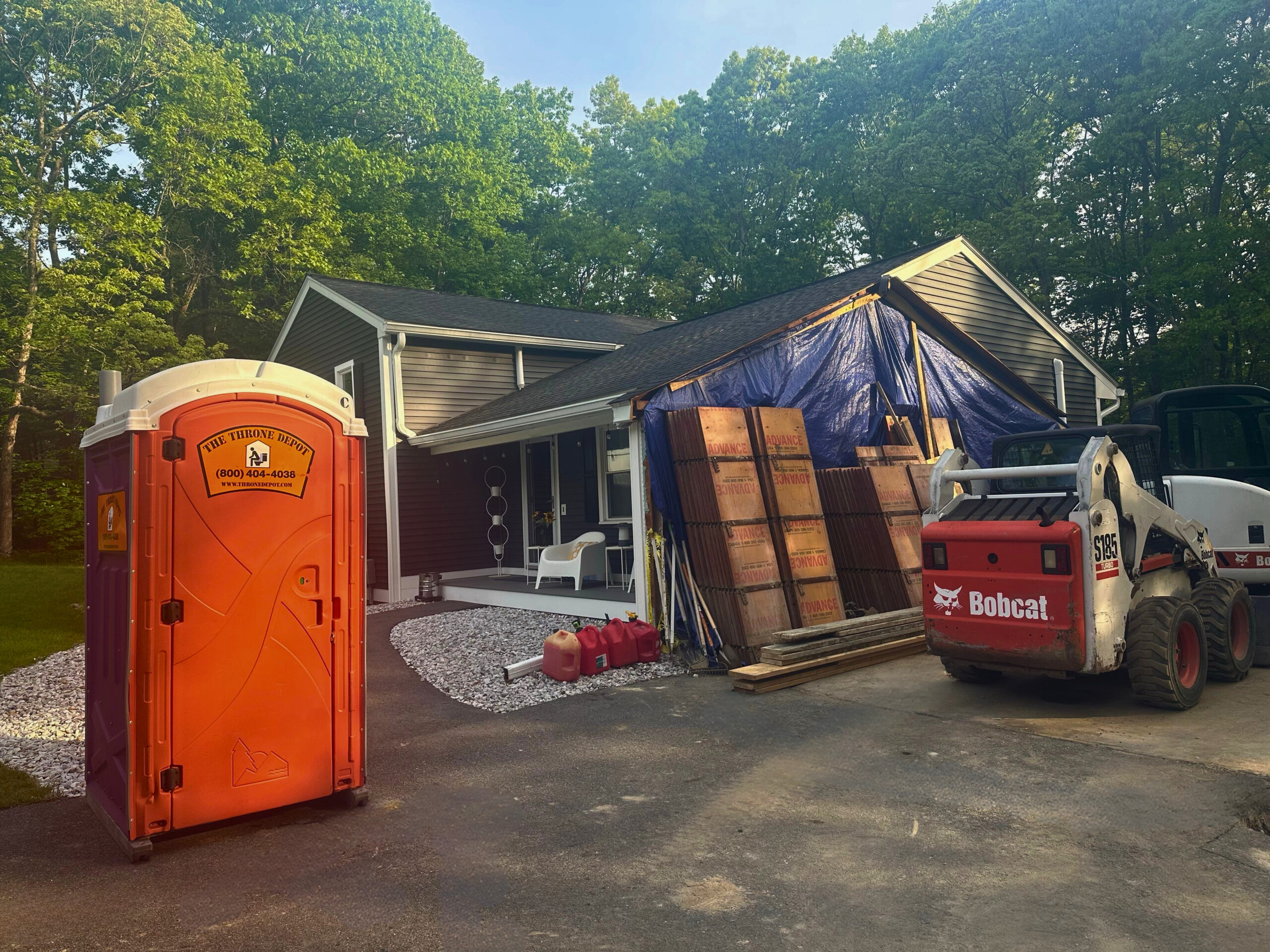 The Throne Depot team standing in front of service trucks and portable restrooms, representing New England’s trusted provider for clean and reliable restroom rentals.