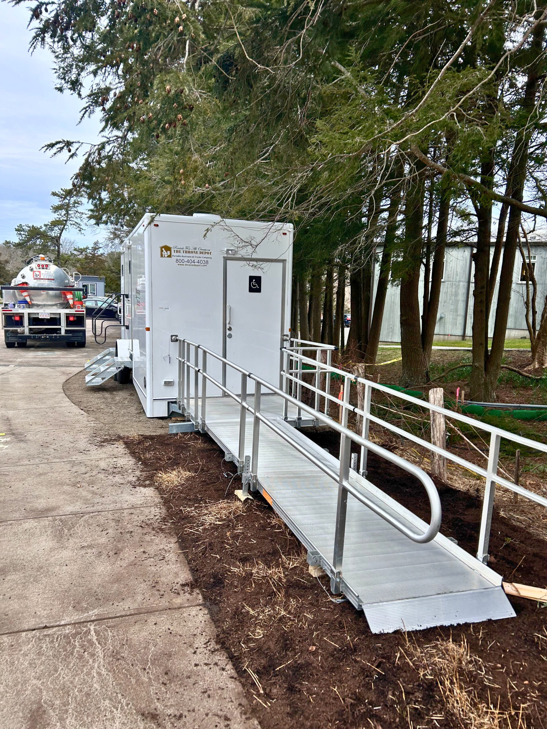 Exterior view of an accessible ADA restroom trailer designed for wheelchair users and mobility needs