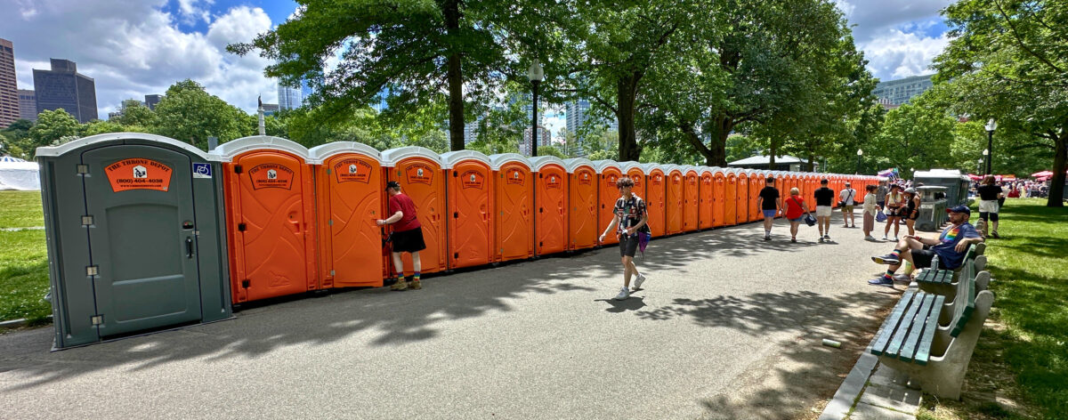 Portable restrooms set up at a festival as part of essential event amenities