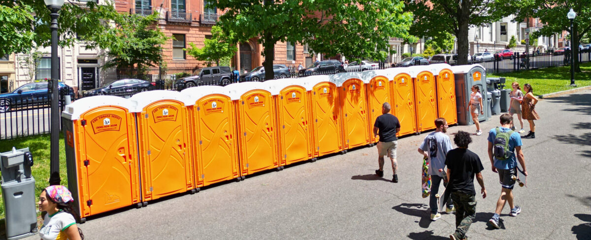 Portable restrooms set up at a large outdoor festival, highlighting the do’s and don’ts of restroom rentals