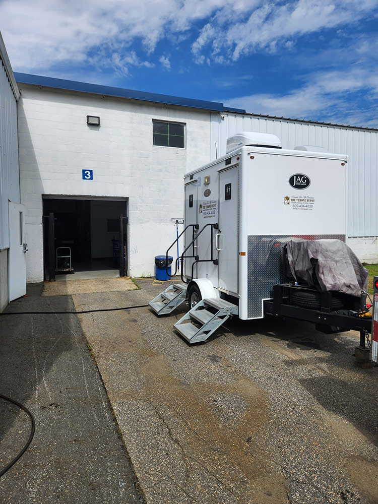 Construction restroom trailer placed onsite offering upgraded amenities for workers