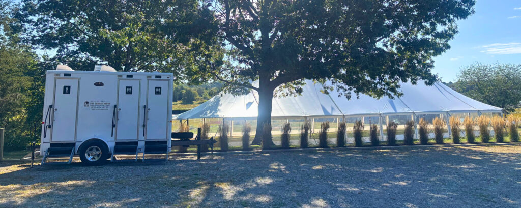 Luxury restroom trailer exterior set up for a wedding, showing the upscale look guests see on arrival