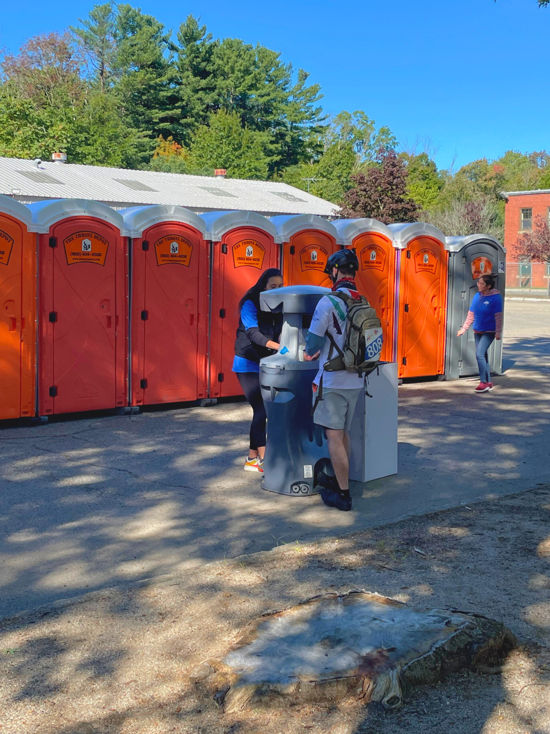Close-up of a portable handwashing station showing faucet, soap, and paper towels