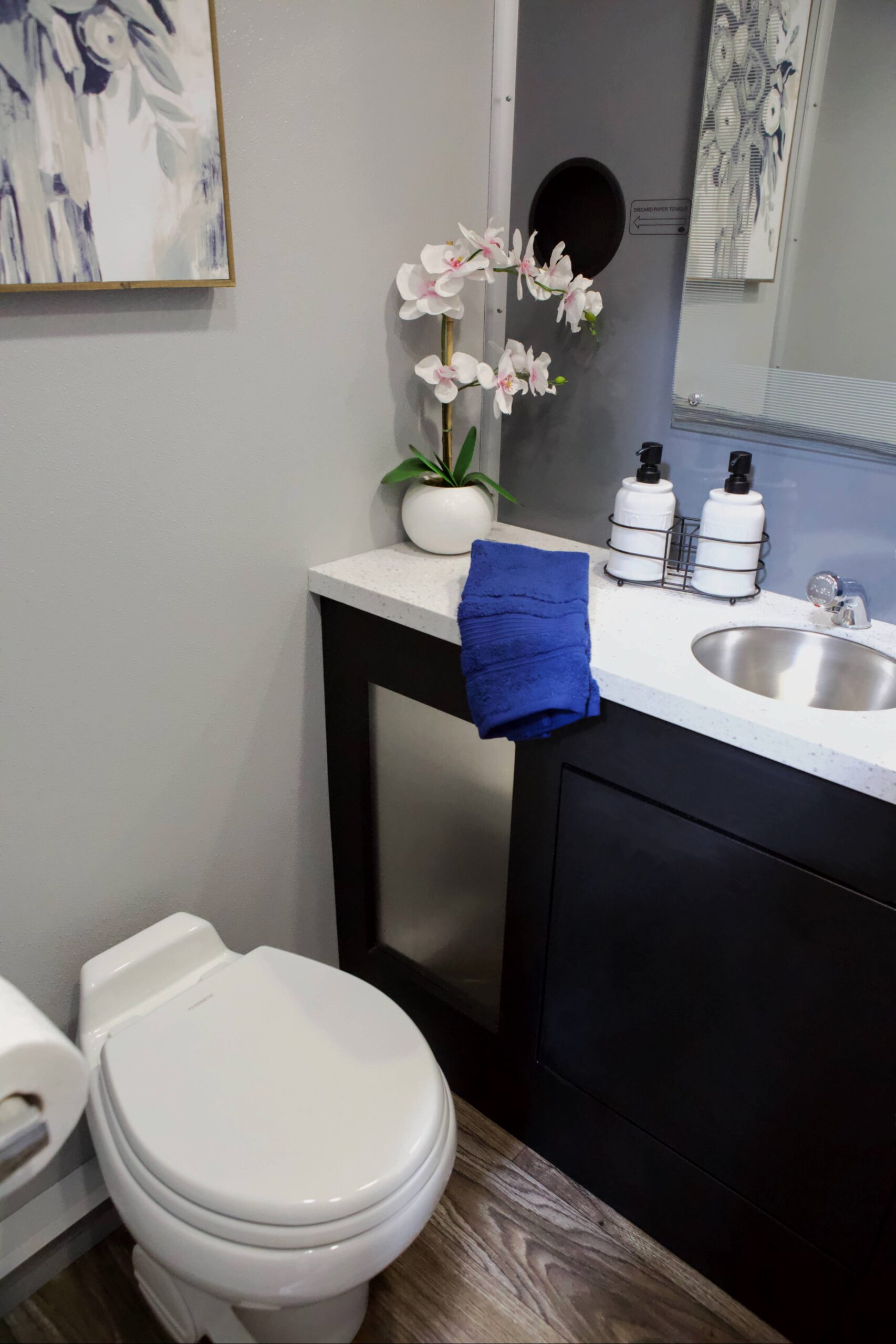 Interior of a restroom trailer showing amenities like sinks, lighting, and climate control for event guests
