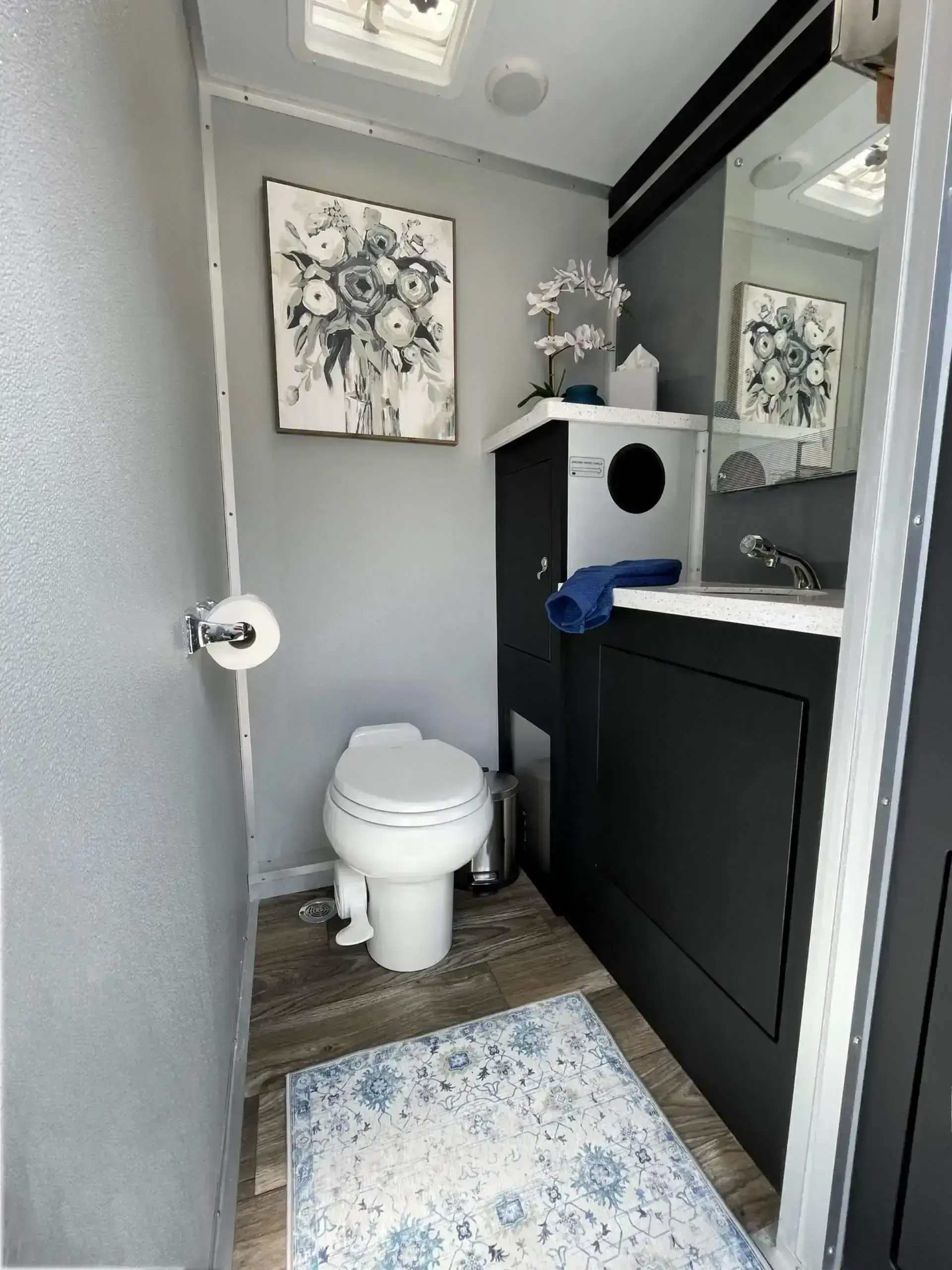 Interior of a restroom trailer showing amenities like climate control, private stalls, and running water