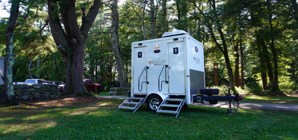 Restroom trailer set up at an outdoor event demonstrating what a restroom trailer looks like