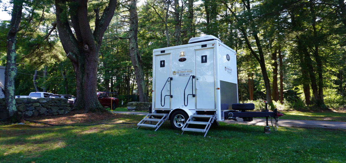 Restroom trailer set up at an outdoor event demonstrating what a restroom trailer looks like