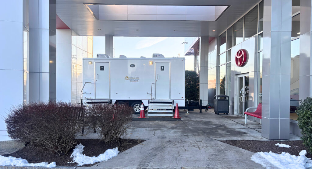 8-stall restroom trailer on site at a business location, providing clean and convenient restroom access for staff and customers