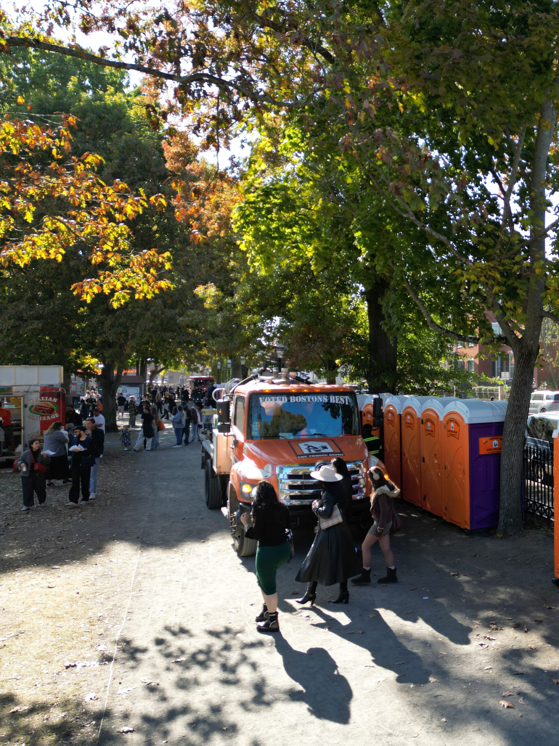 Portable restrooms on Salem Common being serviced by a Throne Depot truck during Haunted Happenings with visitors nearby