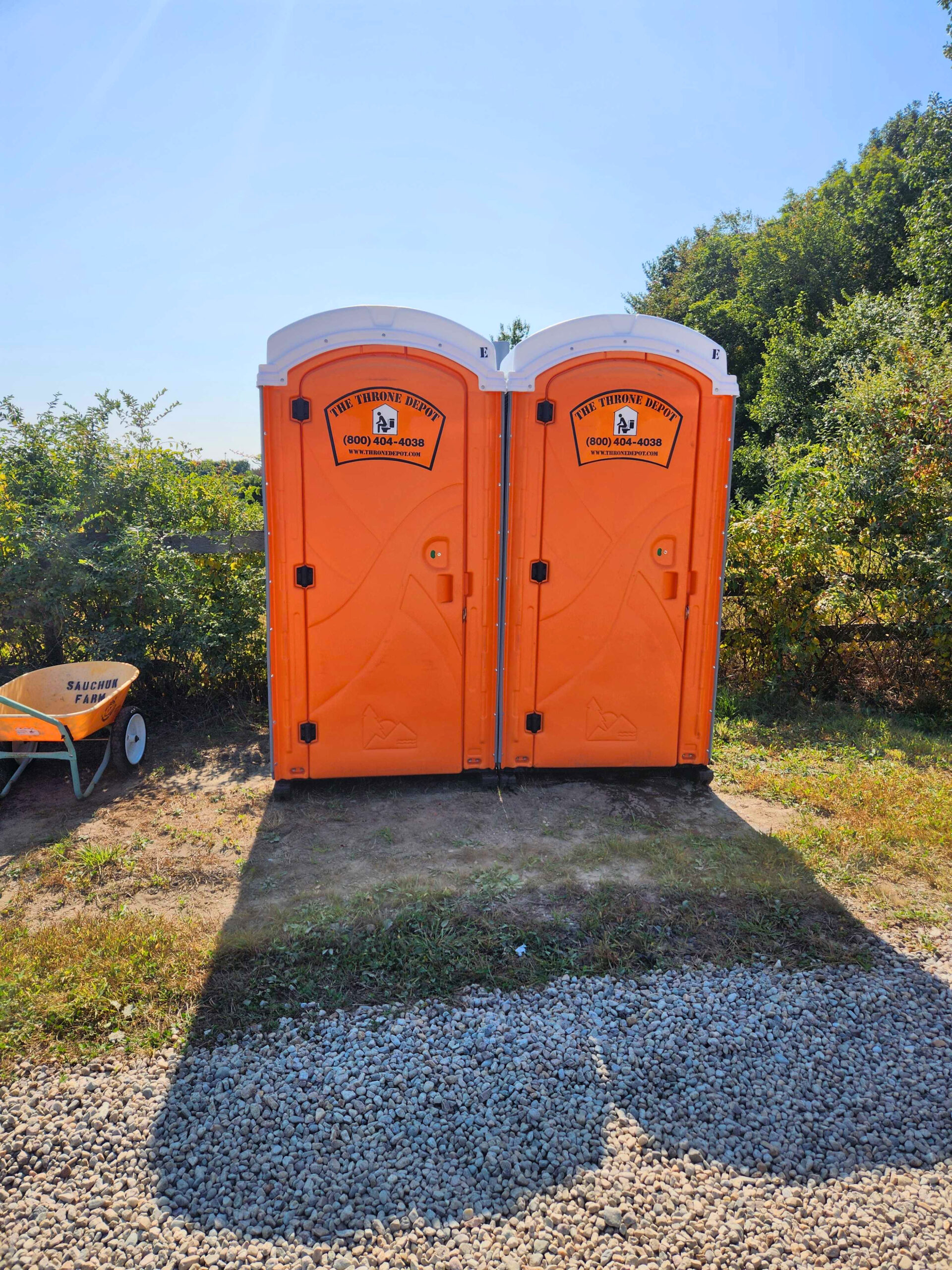 Portable toilets positioned at a farm for agritourism events and seasonal visitors